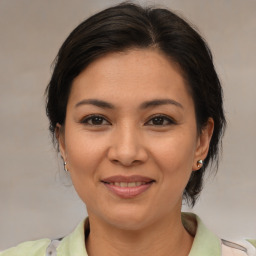 Joyful asian young-adult female with medium  brown hair and brown eyes