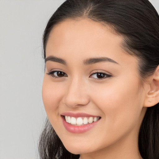 Joyful white young-adult female with long  brown hair and brown eyes