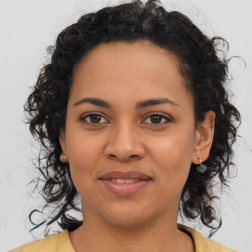 Joyful latino young-adult female with medium  brown hair and brown eyes