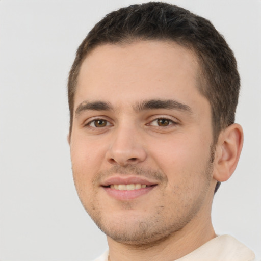 Joyful white young-adult male with short  brown hair and brown eyes