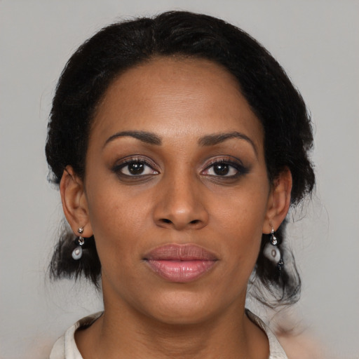 Joyful black young-adult female with medium  black hair and brown eyes