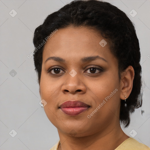 Joyful black young-adult female with short  black hair and brown eyes