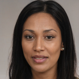 Joyful asian young-adult female with long  brown hair and brown eyes