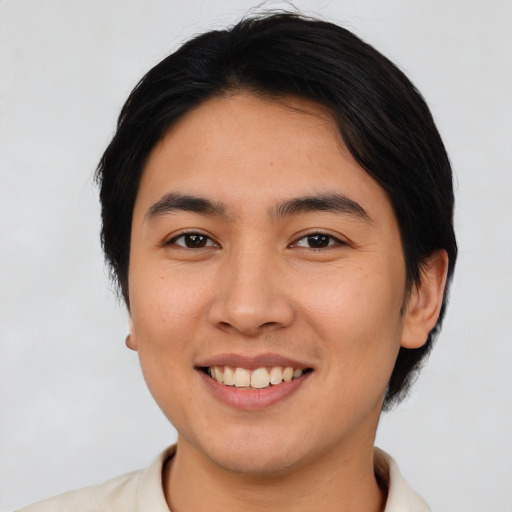 Joyful asian young-adult female with short  black hair and brown eyes