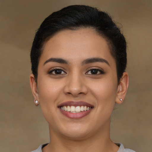 Joyful latino young-adult female with short  brown hair and brown eyes