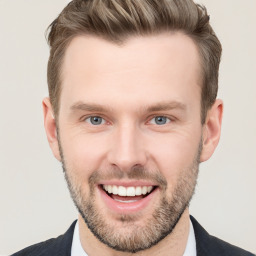 Joyful white young-adult male with short  brown hair and grey eyes