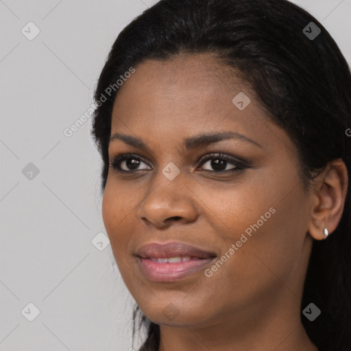 Joyful black young-adult female with long  black hair and brown eyes