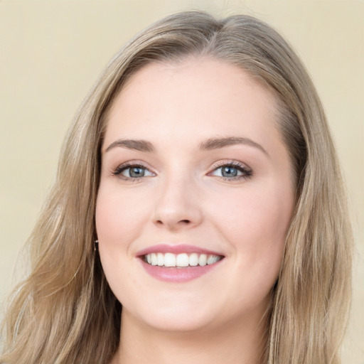 Joyful white young-adult female with long  brown hair and blue eyes