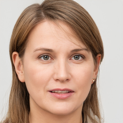 Joyful white young-adult female with long  brown hair and grey eyes