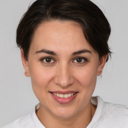 Joyful white young-adult female with medium  brown hair and brown eyes