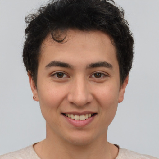 Joyful asian young-adult male with short  brown hair and brown eyes