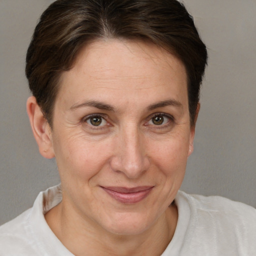 Joyful white adult female with short  brown hair and brown eyes