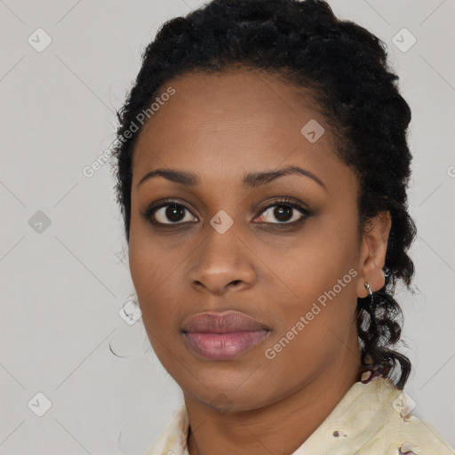 Joyful black young-adult female with long  black hair and brown eyes