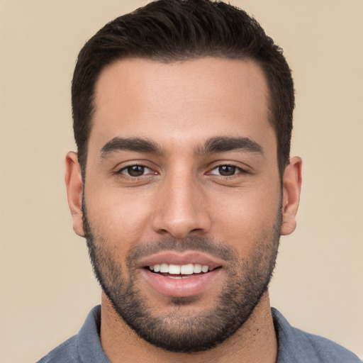 Joyful white young-adult male with short  black hair and brown eyes