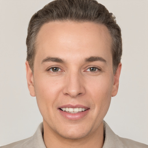 Joyful white adult male with short  brown hair and brown eyes