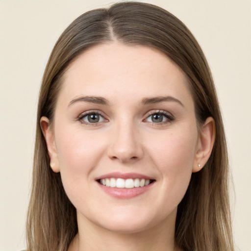 Joyful white young-adult female with long  brown hair and grey eyes