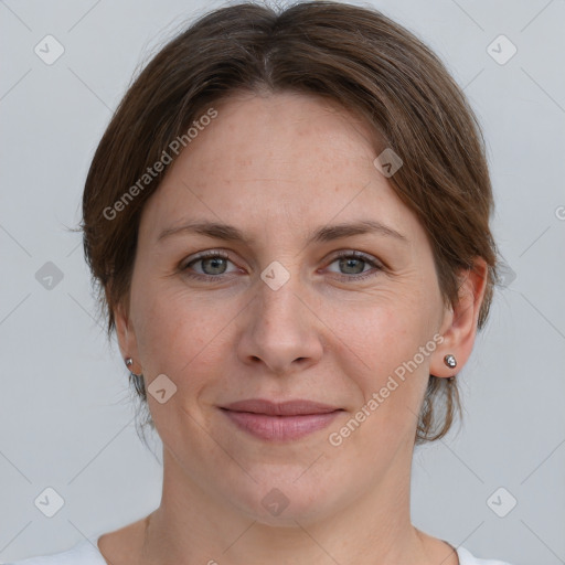 Joyful white adult female with medium  brown hair and grey eyes