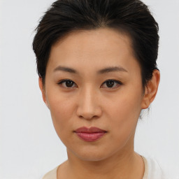 Joyful asian young-adult female with short  brown hair and brown eyes