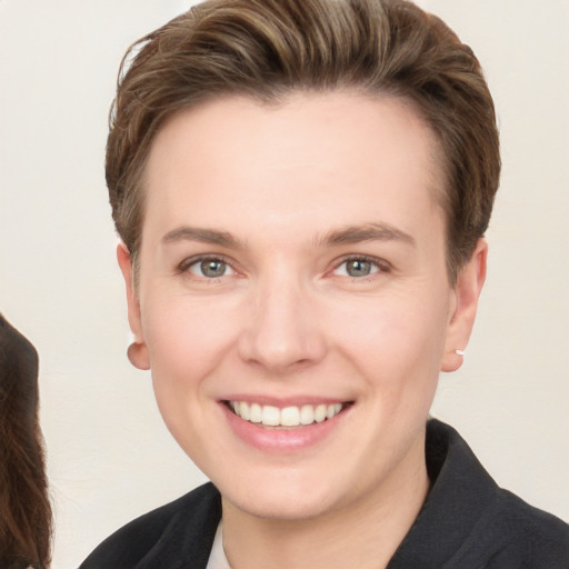 Joyful white young-adult female with short  brown hair and brown eyes