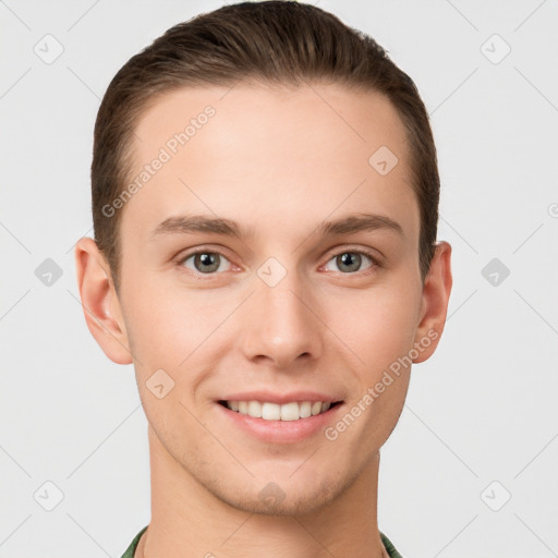 Joyful white young-adult male with short  brown hair and grey eyes