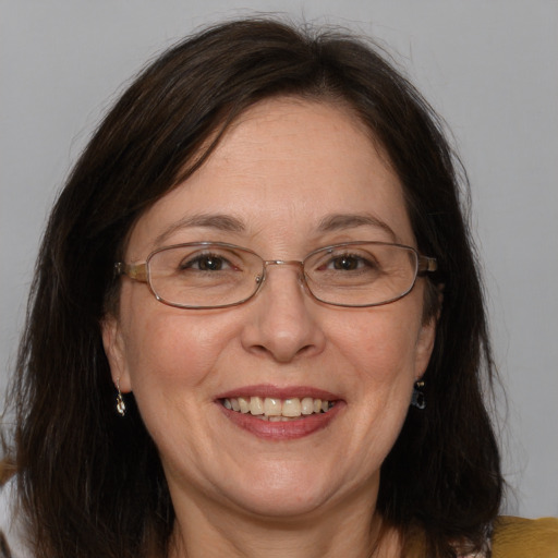 Joyful white adult female with medium  brown hair and brown eyes