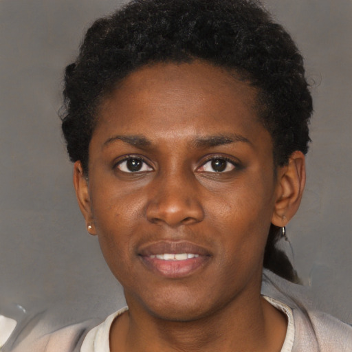Joyful black young-adult female with short  black hair and brown eyes