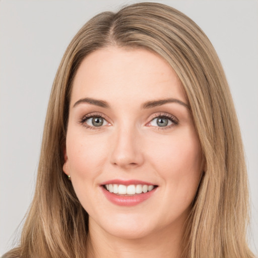 Joyful white young-adult female with long  brown hair and green eyes