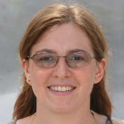 Joyful white adult female with medium  brown hair and brown eyes