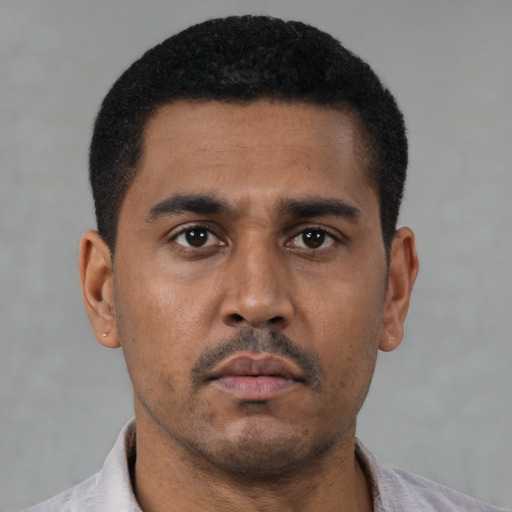 Neutral latino young-adult male with short  black hair and brown eyes