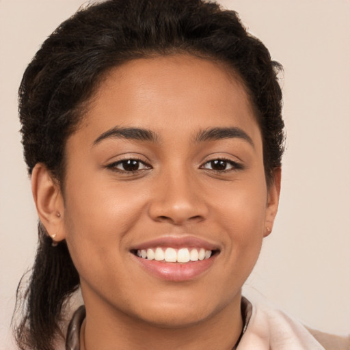 Joyful latino young-adult female with short  brown hair and brown eyes