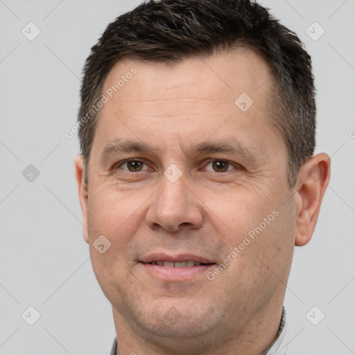 Joyful white adult male with short  brown hair and brown eyes