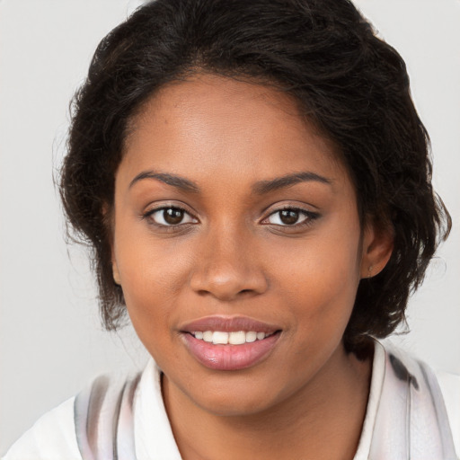 Joyful black young-adult female with long  brown hair and brown eyes