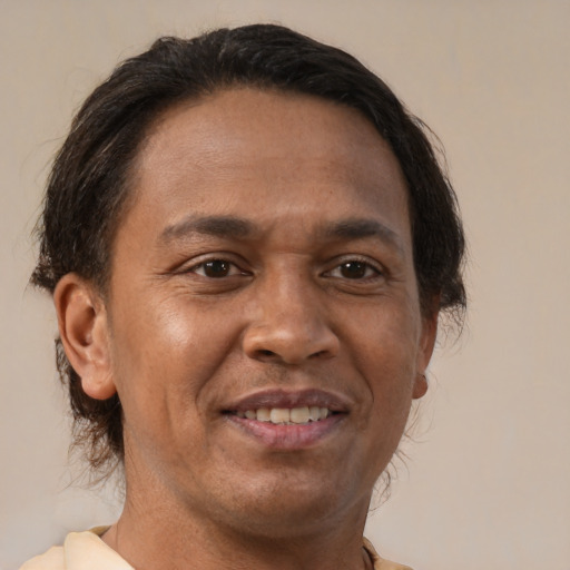 Joyful latino adult male with short  brown hair and brown eyes