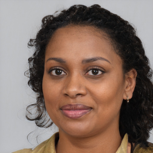 Joyful black young-adult female with medium  brown hair and brown eyes