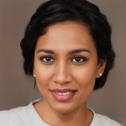 Joyful black young-adult female with medium  brown hair and brown eyes