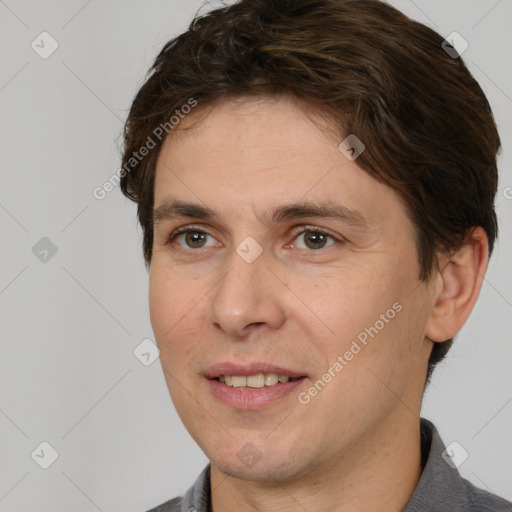 Joyful white adult male with short  brown hair and brown eyes