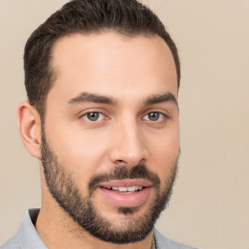 Joyful white young-adult male with short  brown hair and brown eyes