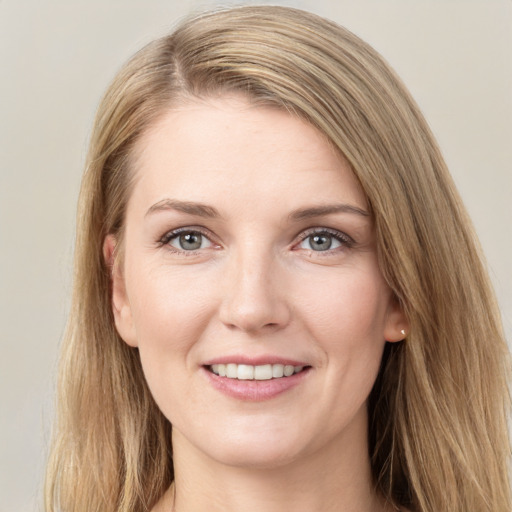 Joyful white young-adult female with long  brown hair and grey eyes