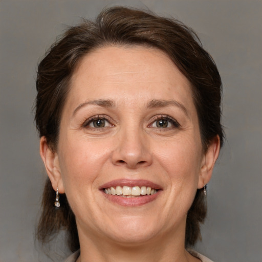 Joyful white adult female with medium  brown hair and brown eyes