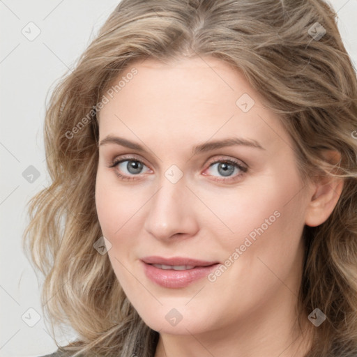 Joyful white young-adult female with medium  brown hair and blue eyes