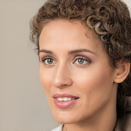 Joyful white young-adult female with medium  brown hair and green eyes