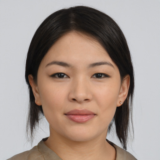 Joyful asian young-adult female with medium  black hair and brown eyes