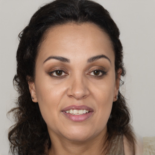 Joyful white adult female with long  brown hair and brown eyes