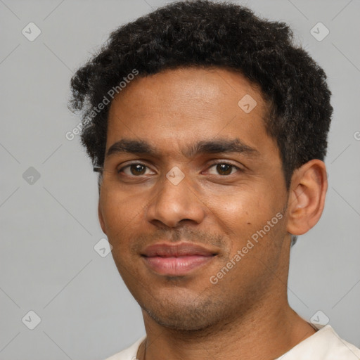 Joyful black young-adult male with short  black hair and brown eyes