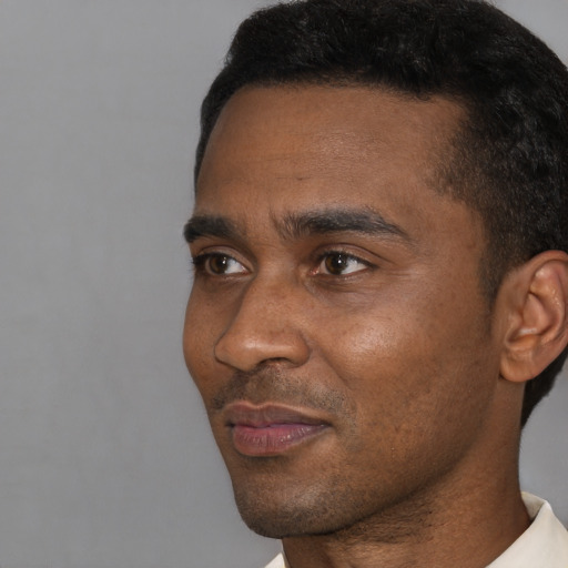 Neutral black young-adult male with short  black hair and brown eyes