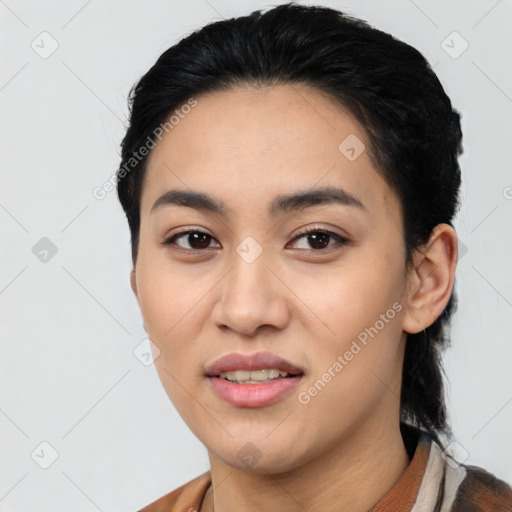 Joyful latino young-adult female with short  black hair and brown eyes