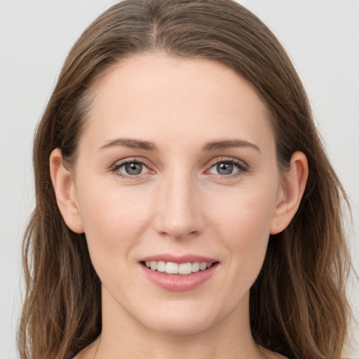 Joyful white young-adult female with long  brown hair and grey eyes