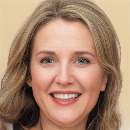 Joyful white adult female with long  brown hair and green eyes