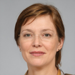 Joyful white adult female with medium  brown hair and grey eyes