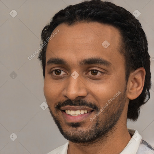 Joyful black young-adult male with short  black hair and brown eyes